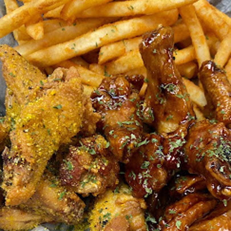 Roll-out Wingz & Eggrolls of Columbia's fried chicken wings, half lemon pepper and half BBQ, with fries.